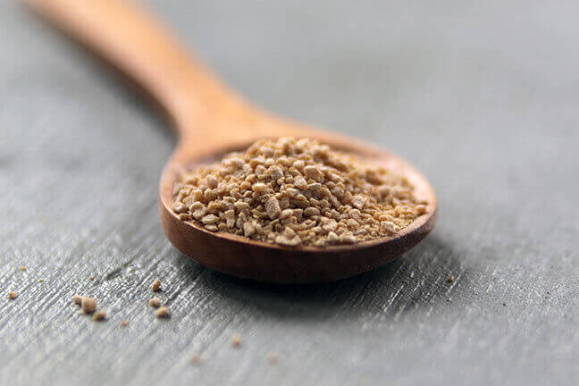 maple sugar in wooden spoon